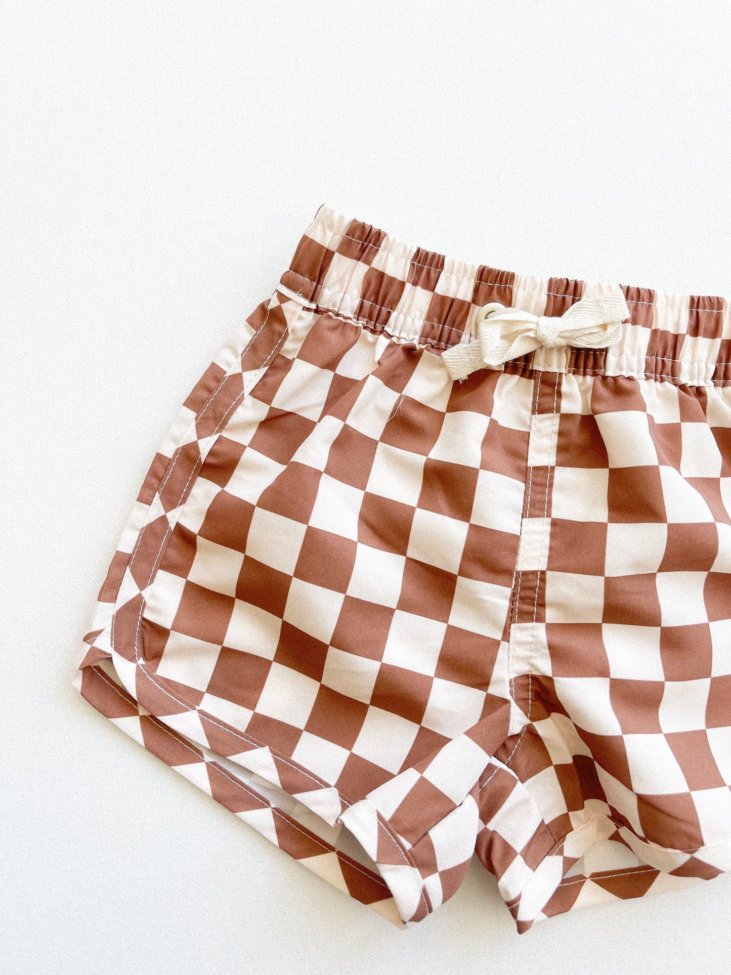 rust checkered swim shorts